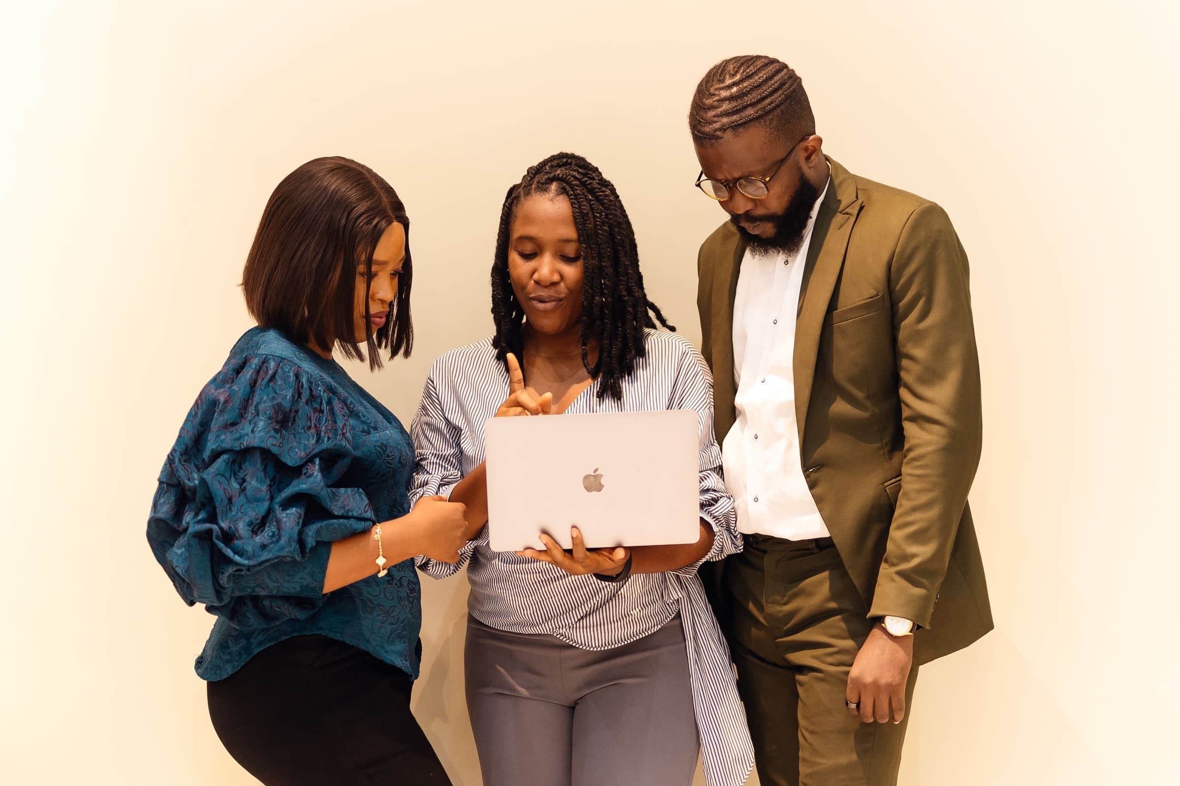 A Webline technology team reviewing work together on a laptop